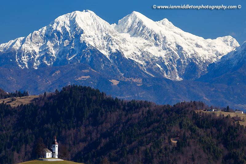 View across to Sveti Tomaz nad Praprotnim (church of Saint Thomas) in the Skofja Loka hills, Slovenia.