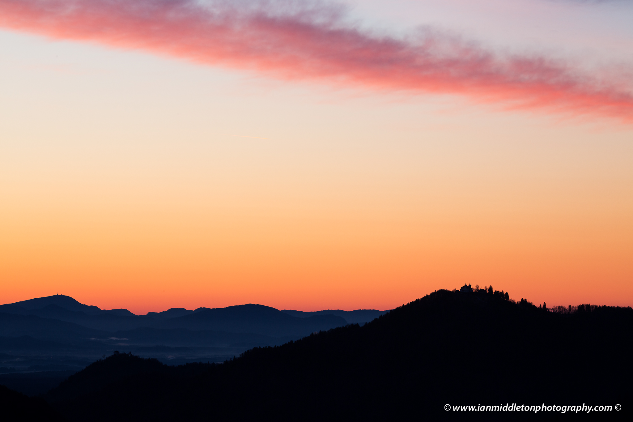 Sunrise view across to the church of Sv Jost above Kranj, Slovenia. Seen from Jamnik.