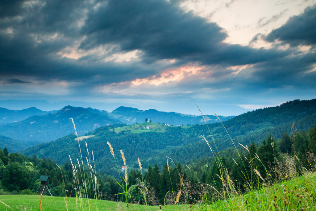 View from Rantovše hill across to Sveti Tomaz nad Praprotnim (church of Saint Thomas) in the Skofja Loka hills, Slovenia.