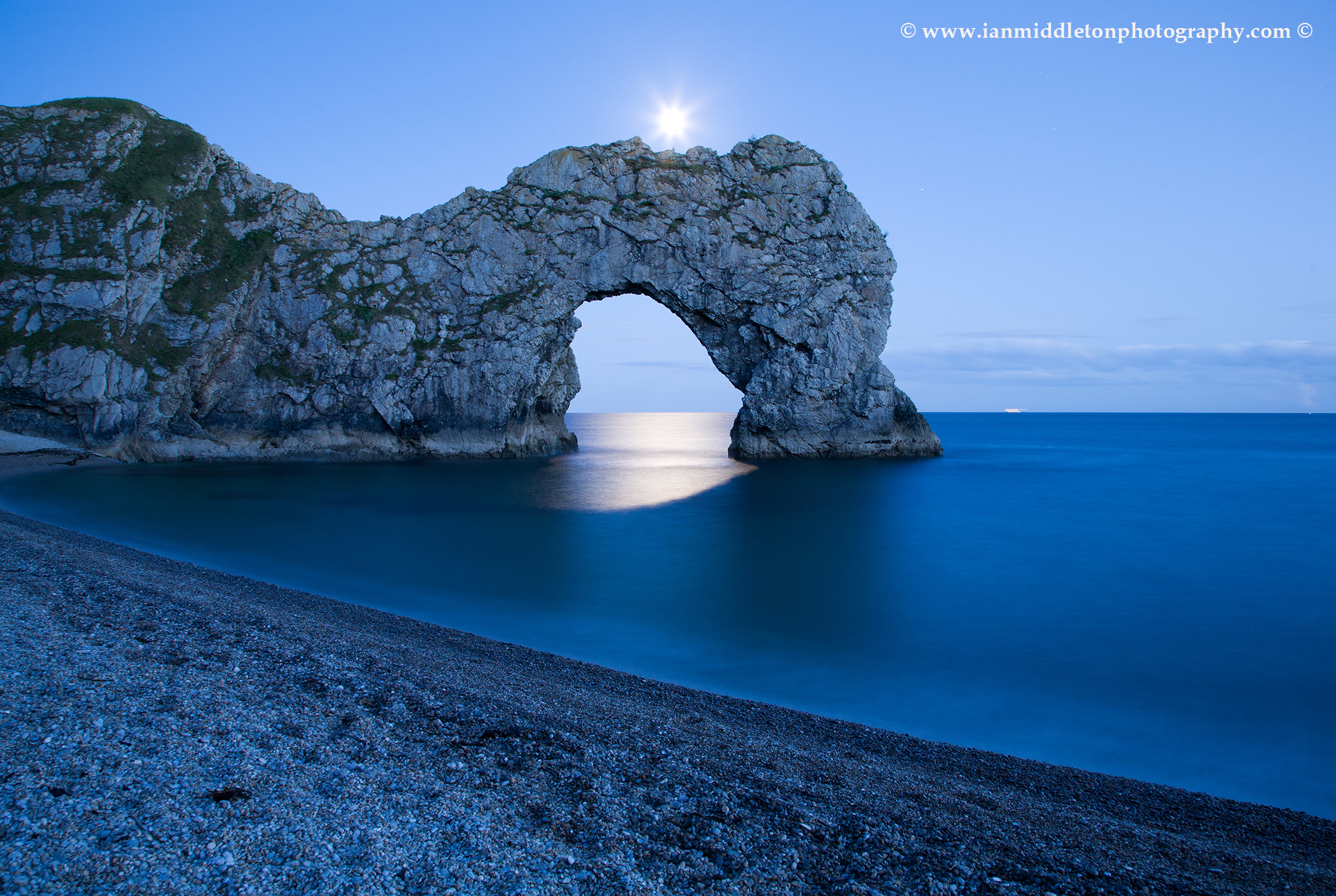Durdle Door in the moonlight, Dorset, England. Captured late evening as the moonlight flooded through the rock's archway. Durdle door is one of the many stunning locations to visit on the Jurassic coast in southern England.