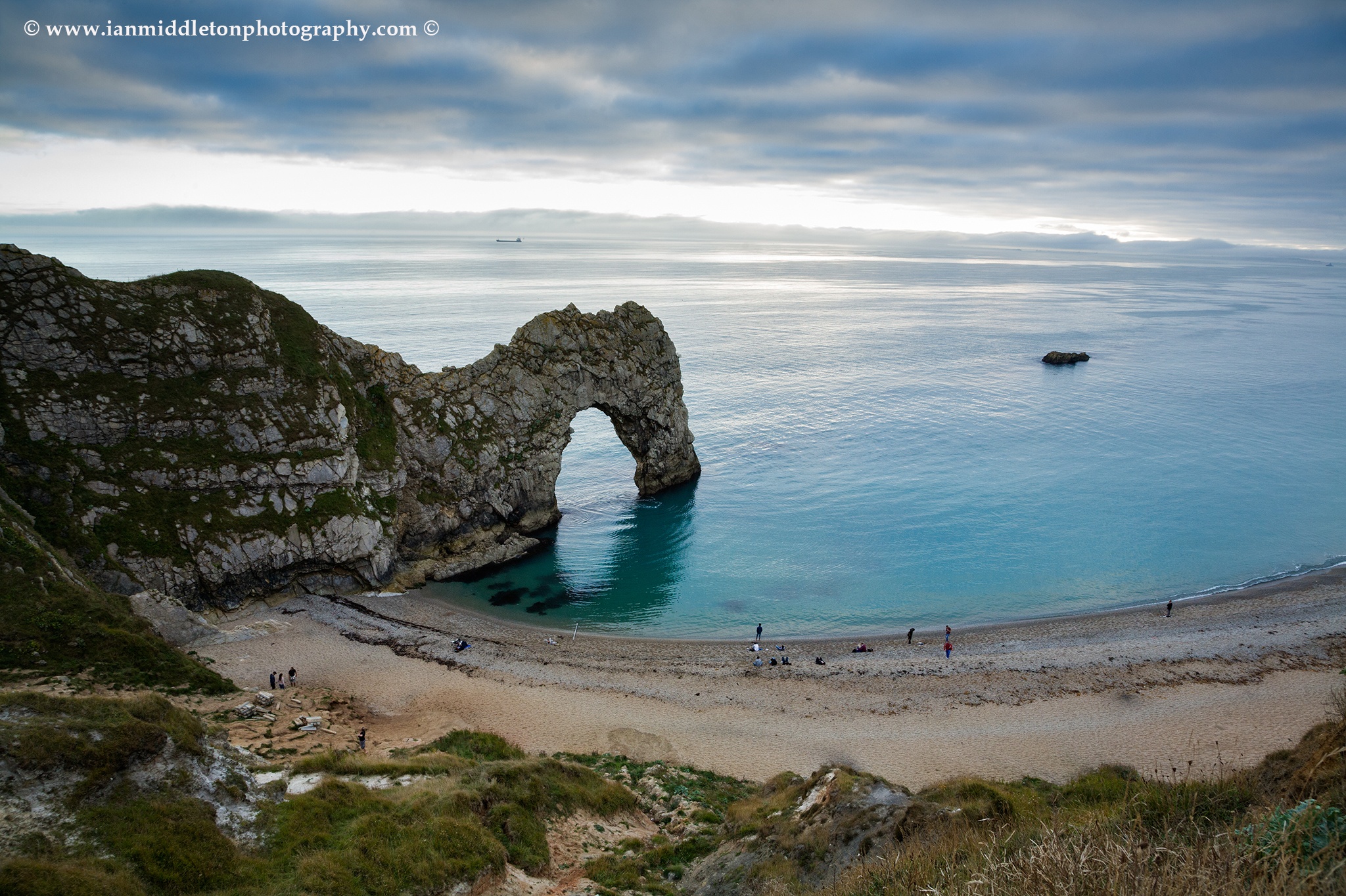 Durdle Door beach as the afternoon cloud breaks up, Dorset, England. Durdle door is one of the many stunning locations to visit on the Jurassic coast in southern England.