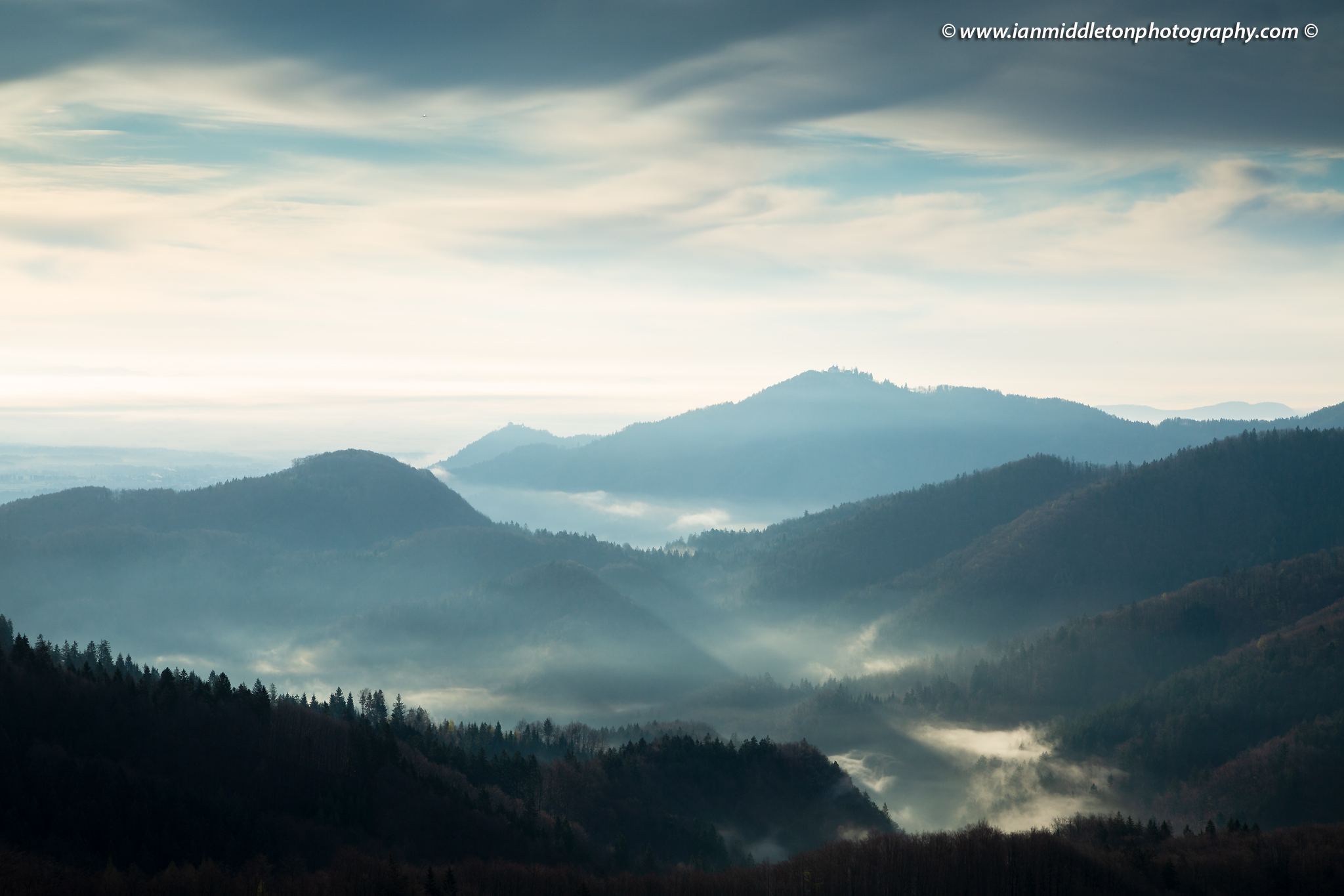 The hills around Jamnik on a spring morning and a view across to the church of Sv Jost above Kranj, Slovenia