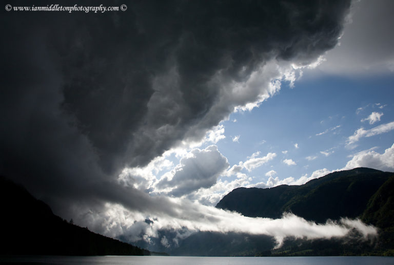 Stormy weather and beautiful light and clouds scattering over Bohinj Lake after a massive storm blew over the Bohinj valley, Triglav National Park, Slovenia.