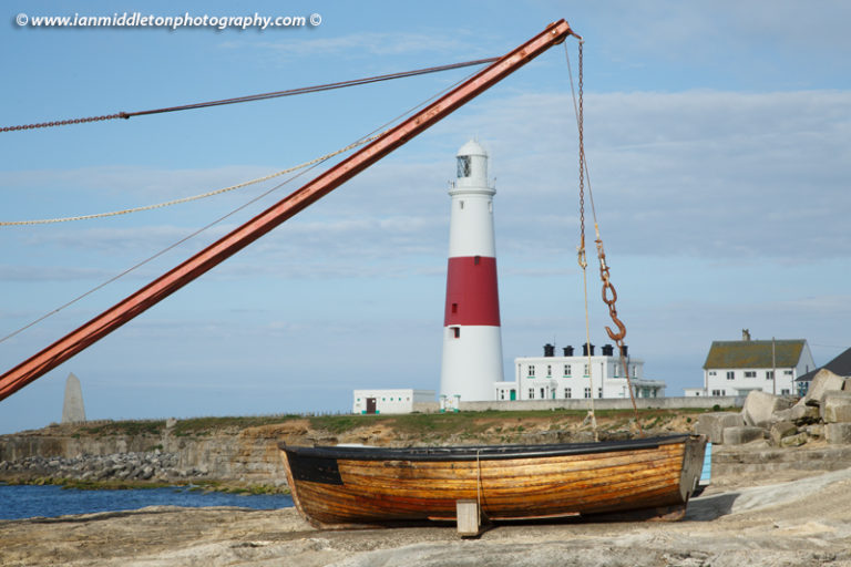 Lighthouse at Portland Bill and the old boat winch in the early morning sun, near Weymouth, Jurassic Coast, Dorset, England.