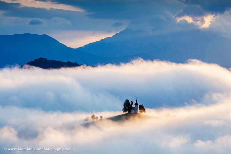 View at sunrise from Rantovše hill across to Sveti Tomaz nad Praprotnim (church of Saint Thomas) and the Kamnik Alps, Slovenia.