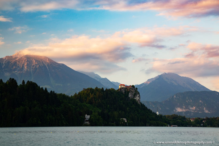 Beautiful light across the beautiful Lake Bled's hilltop castle and Mount Stol, the highest peak in the Karavank Mountains. Slovenia.