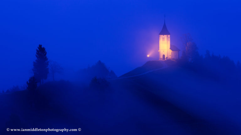 Jamnik church of Saints Primus and Felician at dawn, perched on a hill on the Jelovica Plateau, Slovenia.