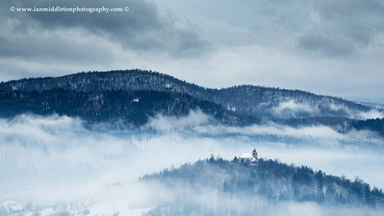 Winter Winter light falling over the church of Sveti Josef (Saint Joseph), Slovenia. Seen from the church of Saint Anna (Sveta Ana). Sveta Ana is perched upon an exposed hill overlooking the Ljubljansko Barje (Ljubljana moors) near the village of Preserje.oWinter light falling over the church of Sveti Josef (Saint Joseph), Slovenia. Seen from the church of Saint Anna (Sveta Ana). Sveta Ana is perched upon an exposed hill overlooking the Ljubljansko Barje (Ljubljana moors) near the village of Preserje