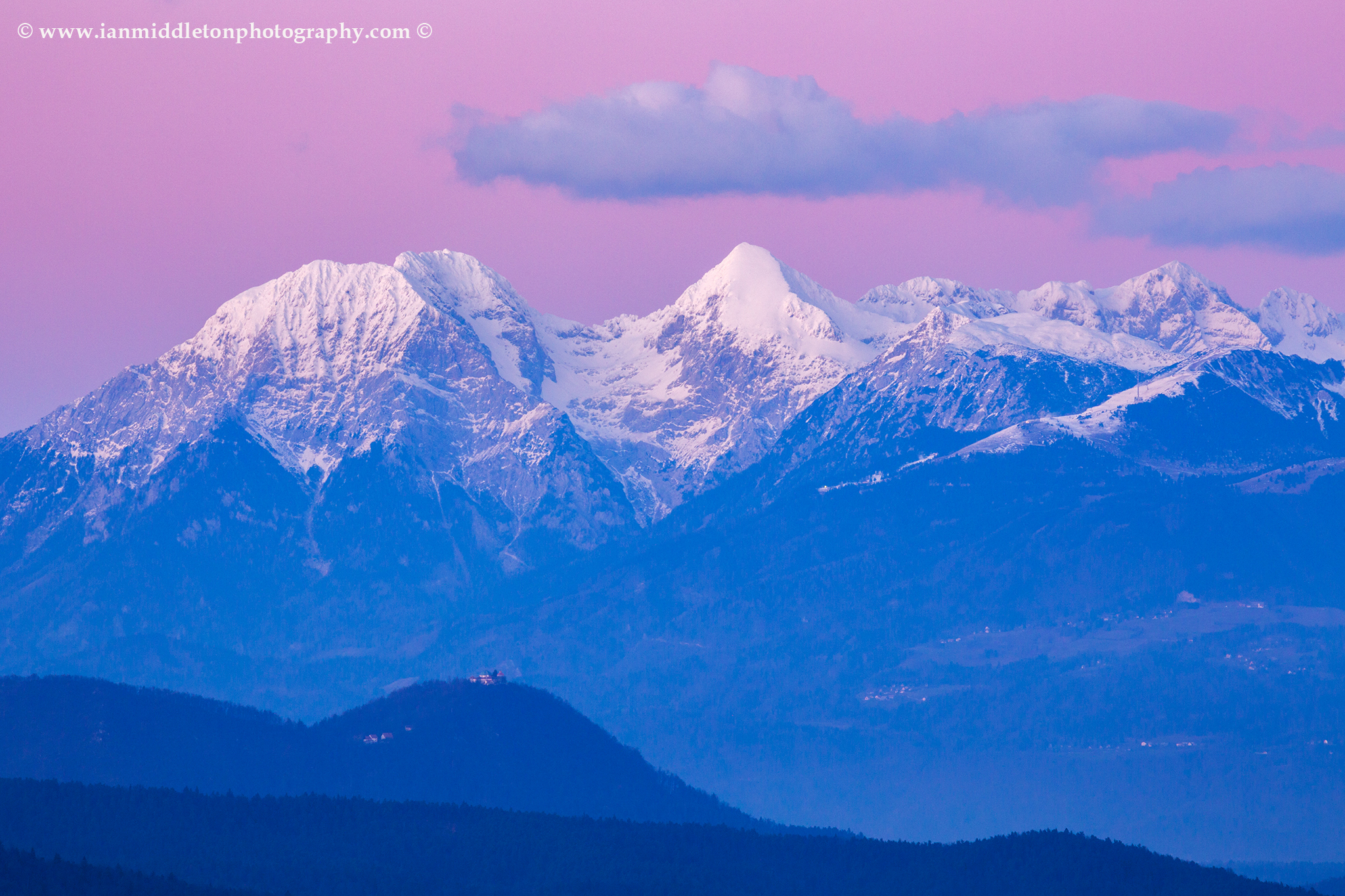 Smarna Gora with the Kamnik Alps behind at sunset, Slovenia. Here you can Mt Grintovec, the highest peak in the kamnik Alps range.