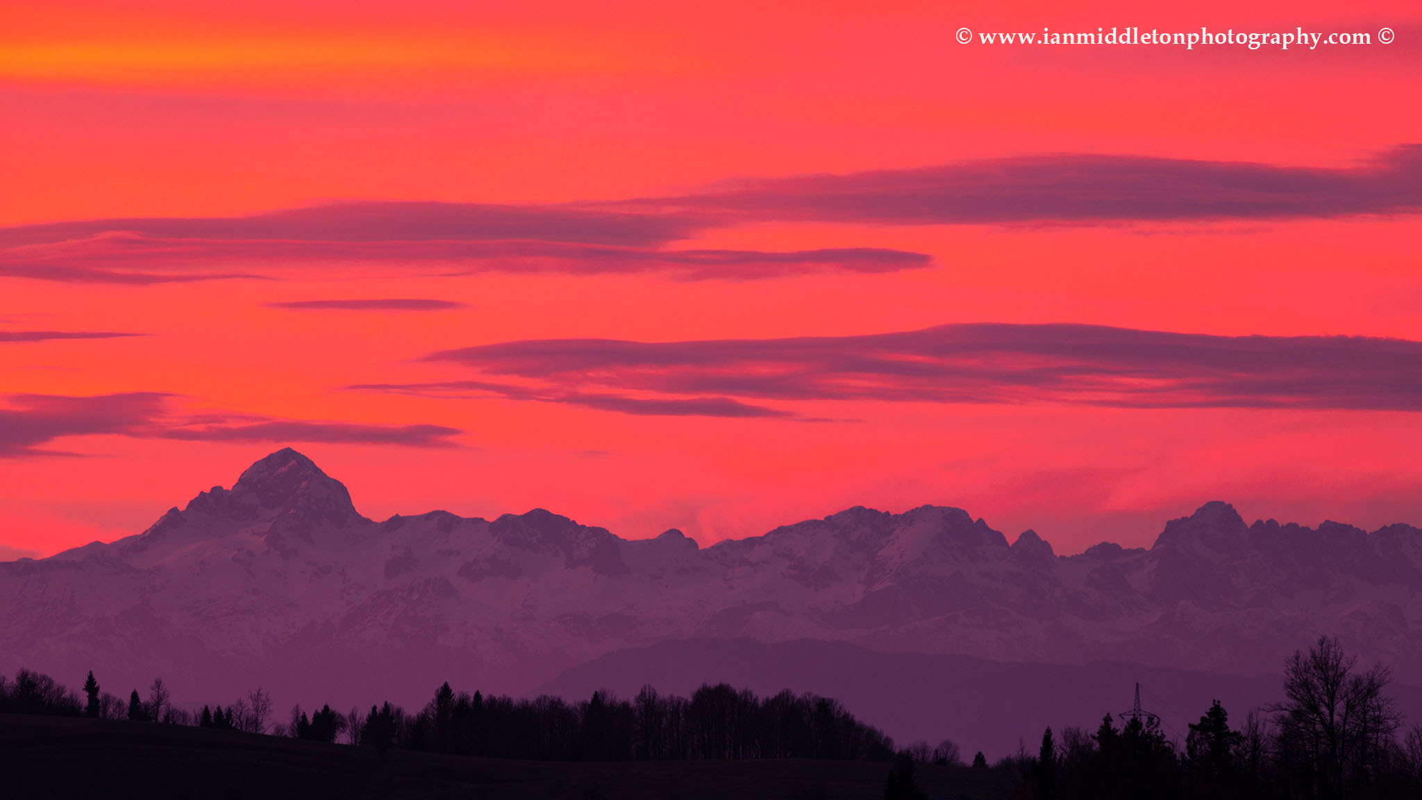View across to the Mount Triglav and the Julian Alps mountains in the west at sunset.
