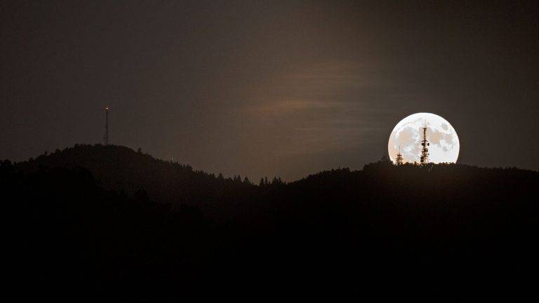 The June 2021 supermoon rising behind Mount Krim on the Ljubljana Moors in Slovenia.