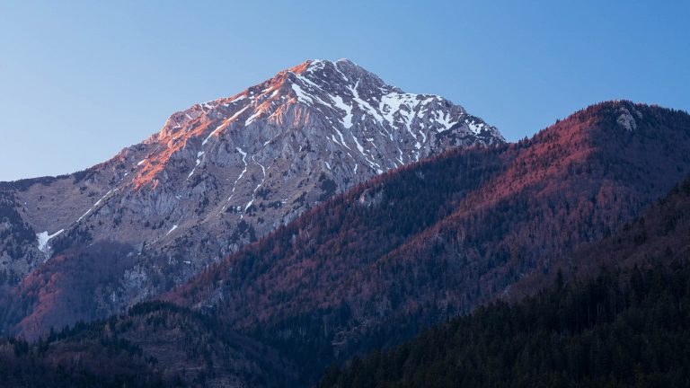 Last light on Mount Storzic in the Kamnik Alps at sunset, seen from Jezero Črnava (black lake) in Preddvor, Gorenjska, Slovenia.