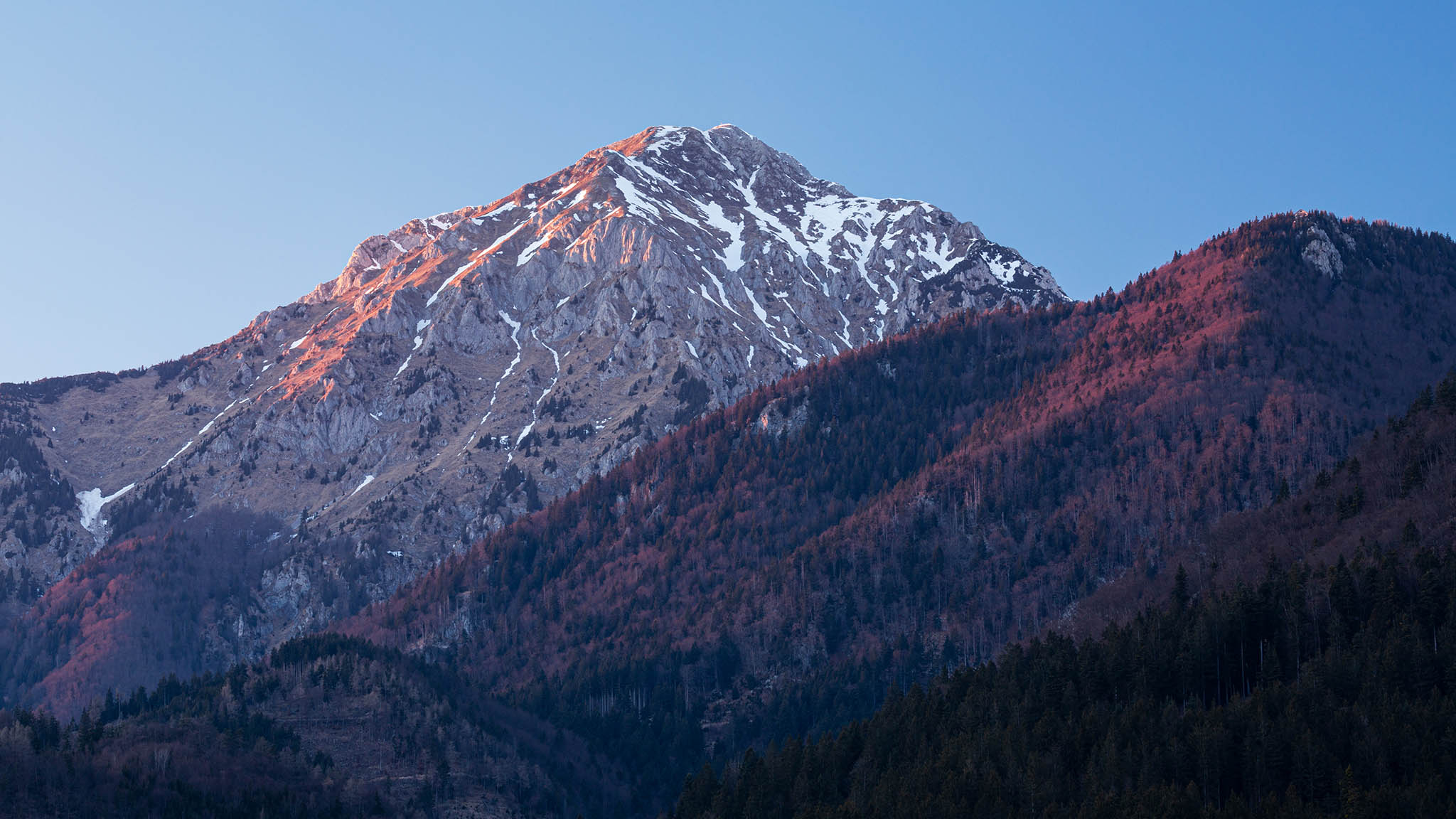 Last light on Mount Storzic in the Kamnik Alps at sunset, seen from Jezero Črnava (black lake) in Preddvor, Gorenjska, Slovenia.