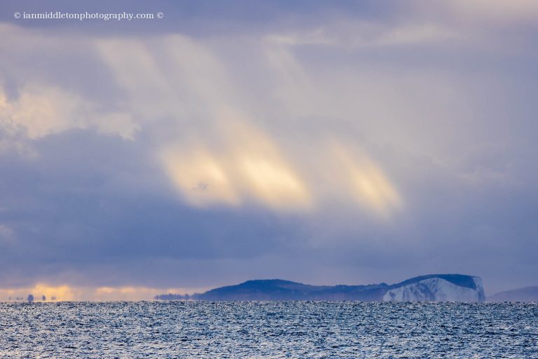 Morning light over the Isle of Wight, seen from Swanage seafront in Dorset, England.