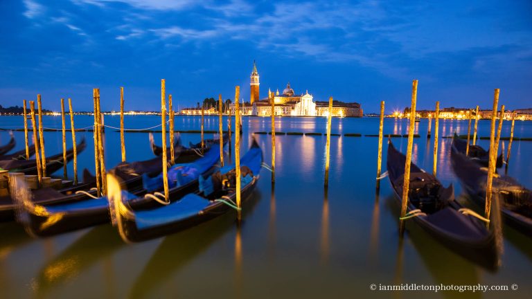 Gondolas at dawn with the Church of San Giorgio Maggiore over the Grand Canal in Venice, Italy.