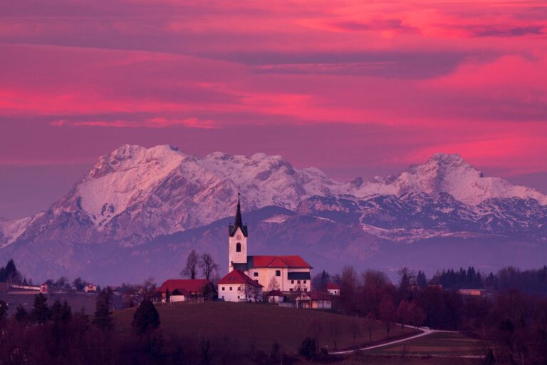 Prezganje church with snowy Kamnik Alps in the background