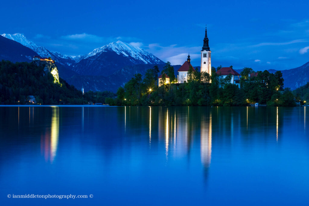 View across the beautiful Lake Bled, island church at dusk, Slovenia. Lake Bled is Slovenia's most popular tourist destination