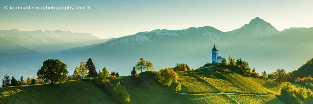 Morning at Jamnik church with the Kamnik Alps and Karavanke Alps