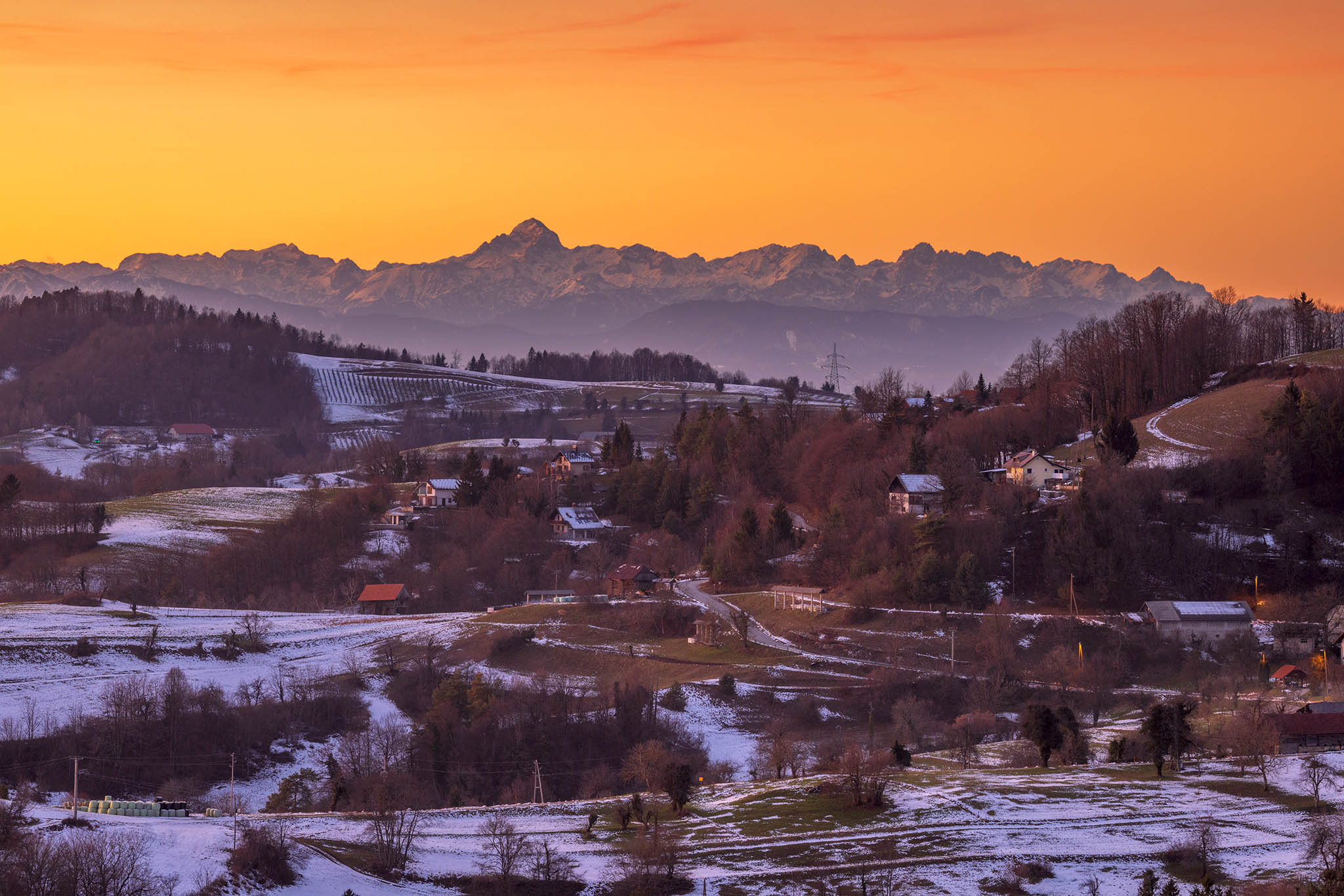 View across the village of Volavje to the Julian Alps mountains in the west. Volavlje is a small village in the hills east of Ljubljana, Slovenia.