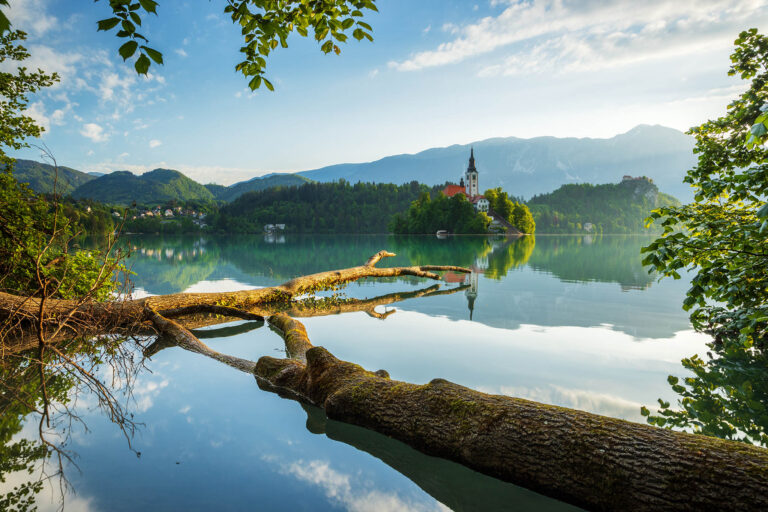 View across Lake Bled to the island church, clifftop castle and Mount Stol, Slovenia