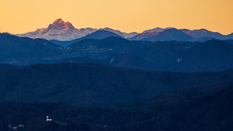 View of Mount Triglav at sunset from Saint Ana church hill on the Ljubljana Marshes, Slovenia.
