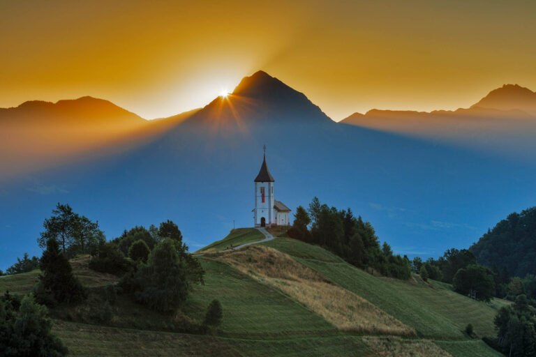 Sunrise over Storzic Peak and Jamnik Church