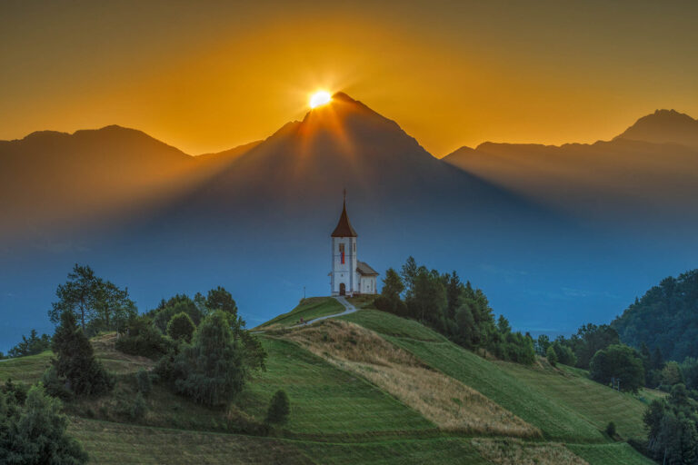 Sunrise over Storzic Peak and Jamnik Church